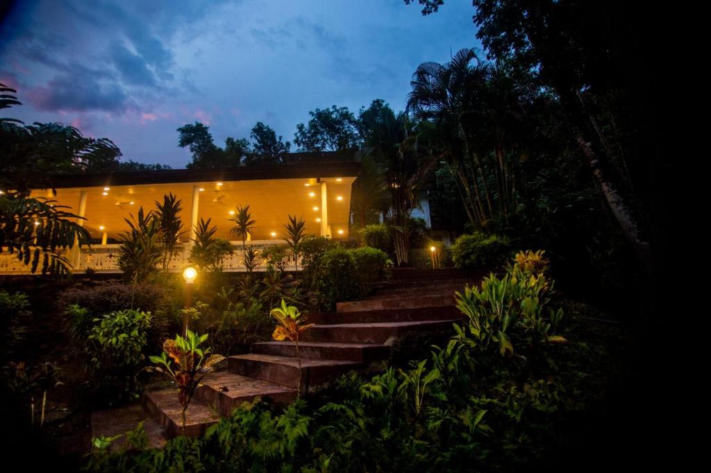 a building with stairs in front of it with lights at Adventure base camp Miyora in Kitulgala