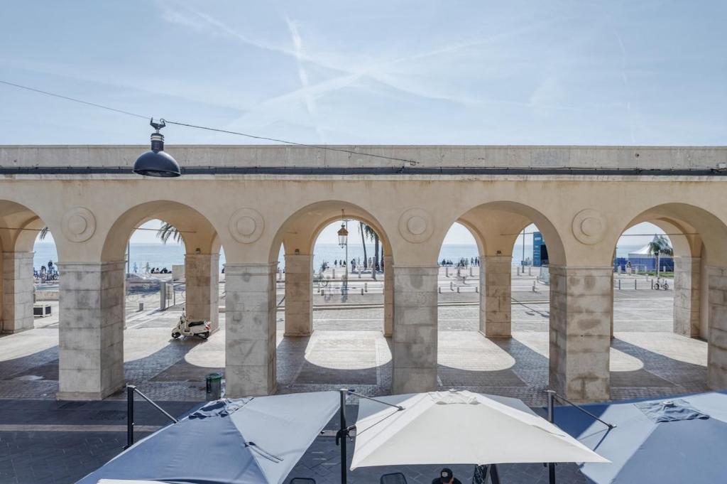 a group of tents in front of a building with arches at Superbe Appartement Au Coeur du Vieux Nice ! in Nice