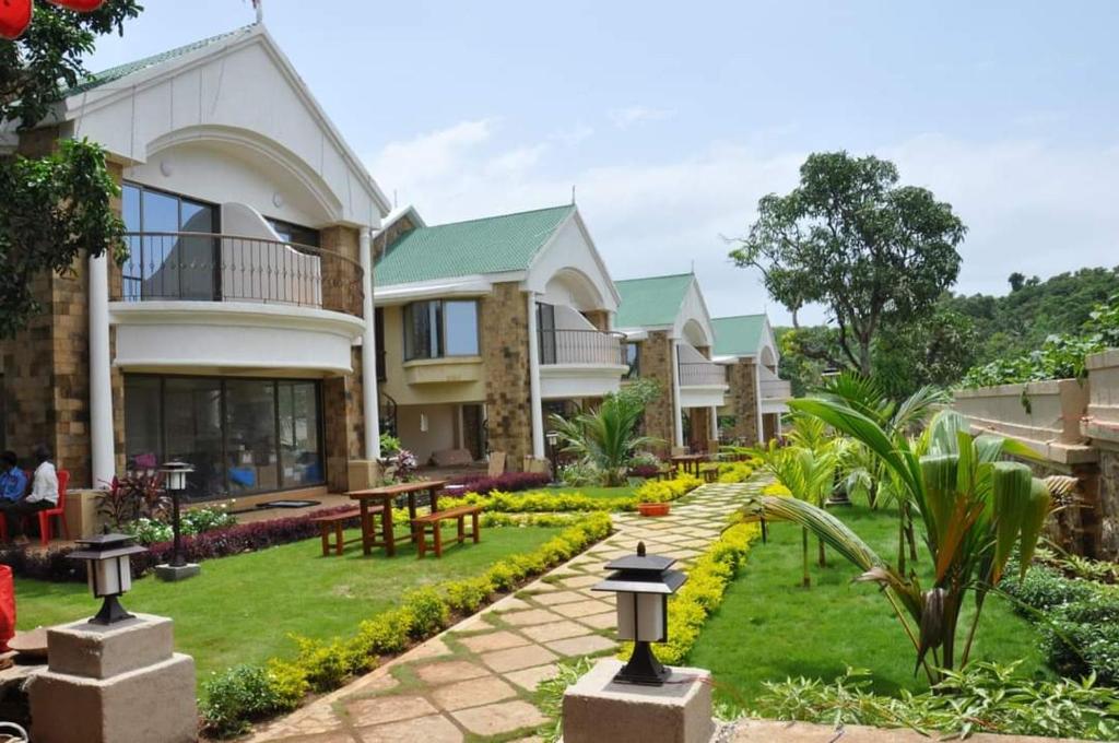 a house with a garden in front of it at Silverador Resort in Thane