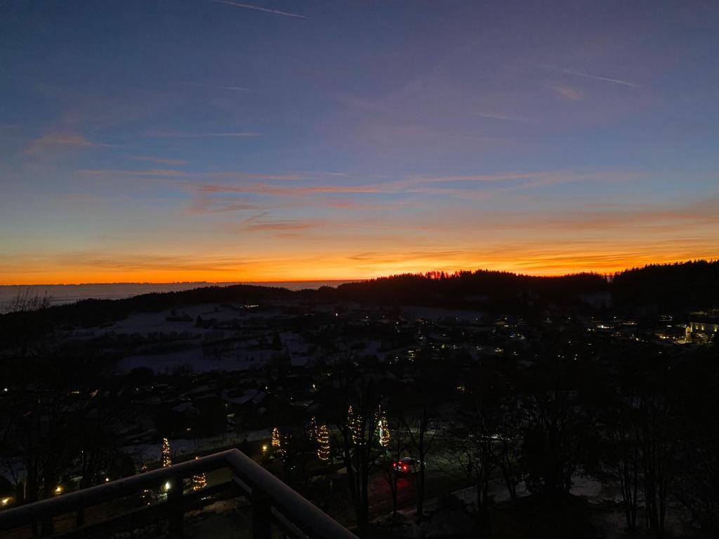 a view of the sunset from the balcony of a building at FeWo Panoramablick mit Pool und Sauna inklusive in Sankt Englmar