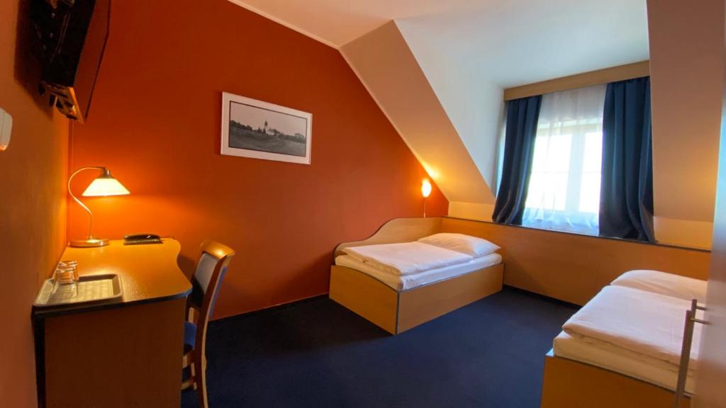 Postel nebo postele na pokoji v ubytování Hotel U Milína