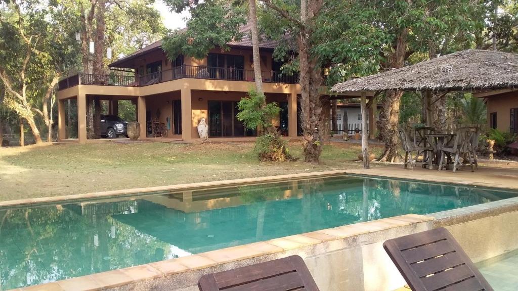 a house with a swimming pool in front of a house at KhaoTong Villa at Melina's in Tha Lane Bay