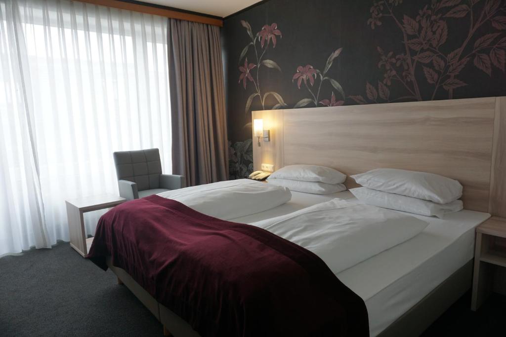 Postel nebo postele na pokoji v ubytování Hotel Senator München