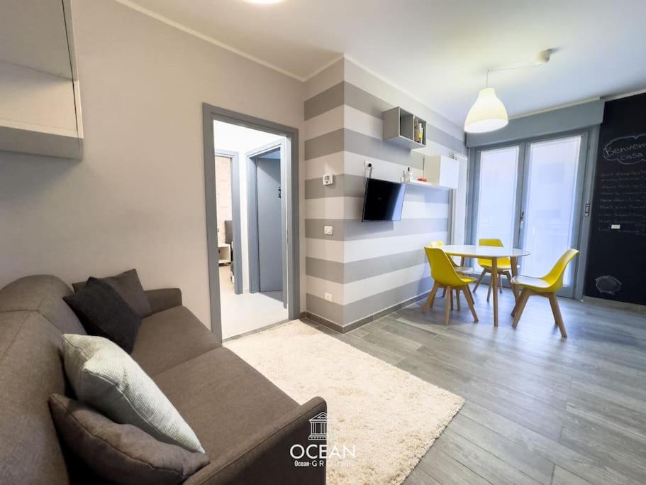 a living room with a couch and a table at GoldenSuitesItaly I Trento Suite 1 & Garage Privato in Trento