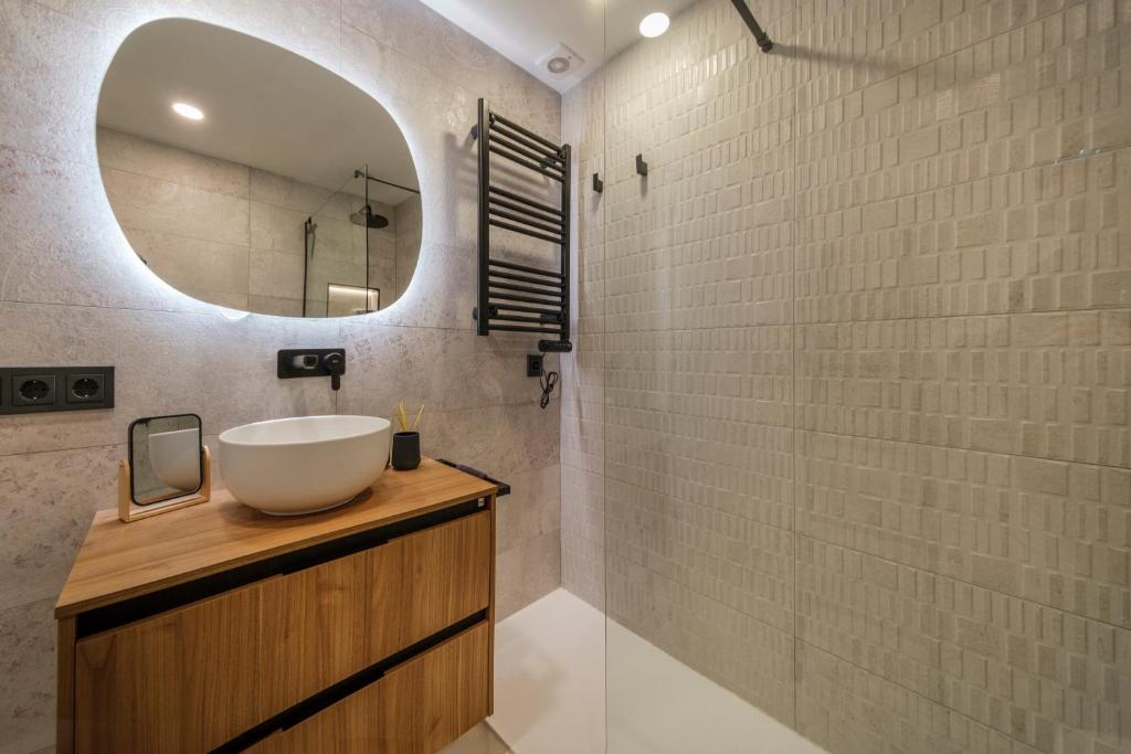 a bathroom with a sink and a mirror at Alma Libre Beach Apartment in Colònia de Sant Jordi