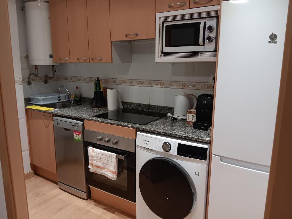 a kitchen with a microwave and a dishwasher at Brisas del Mar in Salou