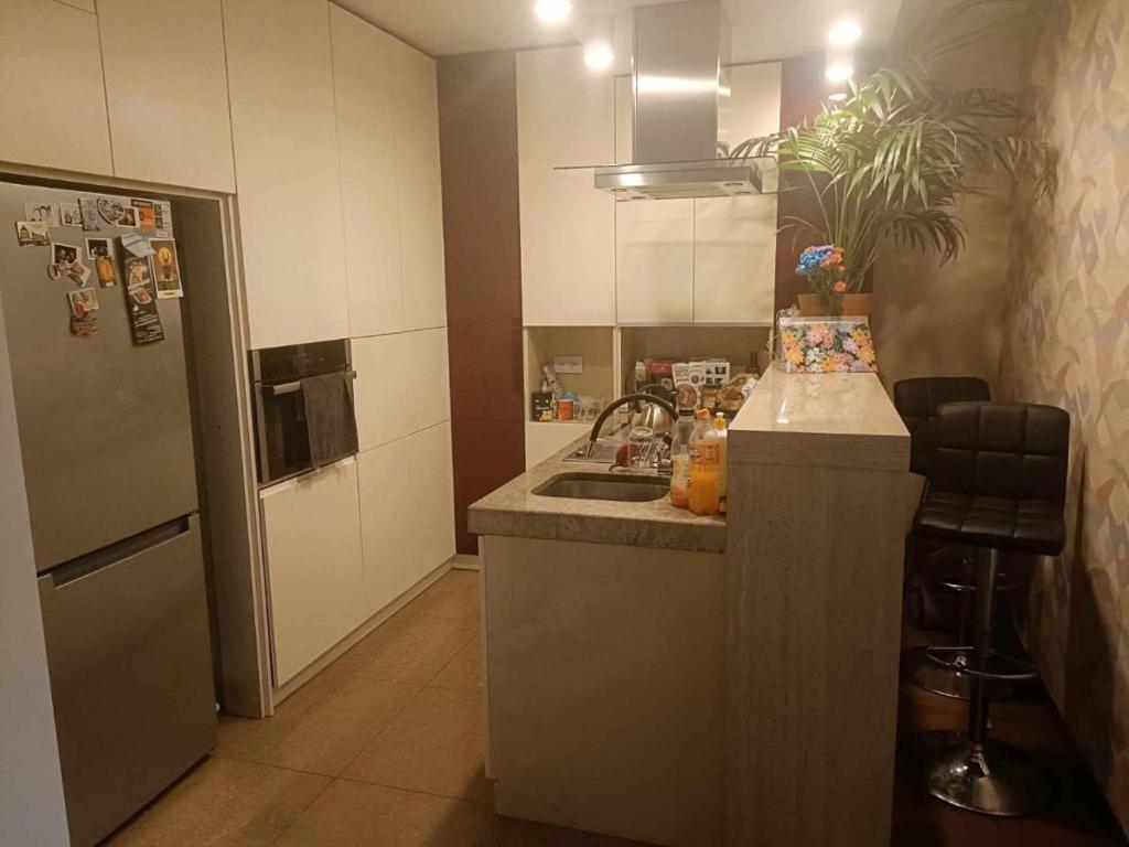 a small kitchen with a sink and a refrigerator at Zakrzowek rent in Krakow