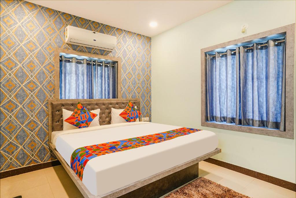 a bedroom with a bed and a window at FabHotel Lio7 Grand in Hyderabad