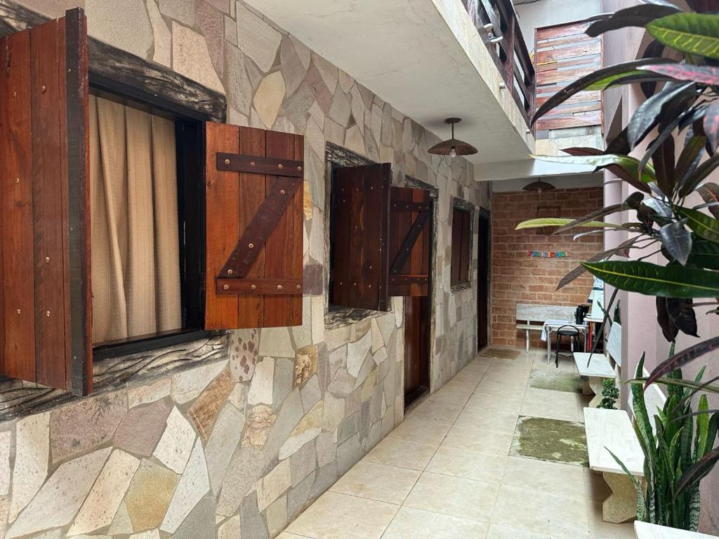 a hallway of a building with a tile wall at Pousada Rústica in São Thomé das Letras