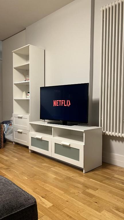 a white entertainment center with a television in a living room at Luxury 1-Bed Apartment in the heart of Leicester in Leicester
