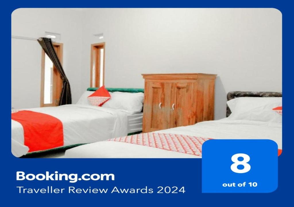 מיטה או מיטות בחדר ב-OYO 605 Queen Homestay