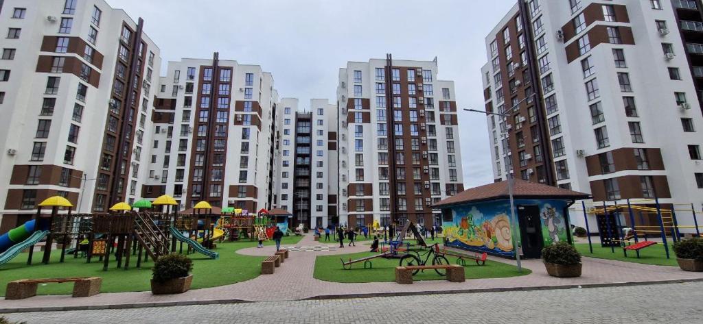 キシナウにあるDecebal Lux Apartmentの高層アパートメントの建物が並ぶ都市の遊び場
