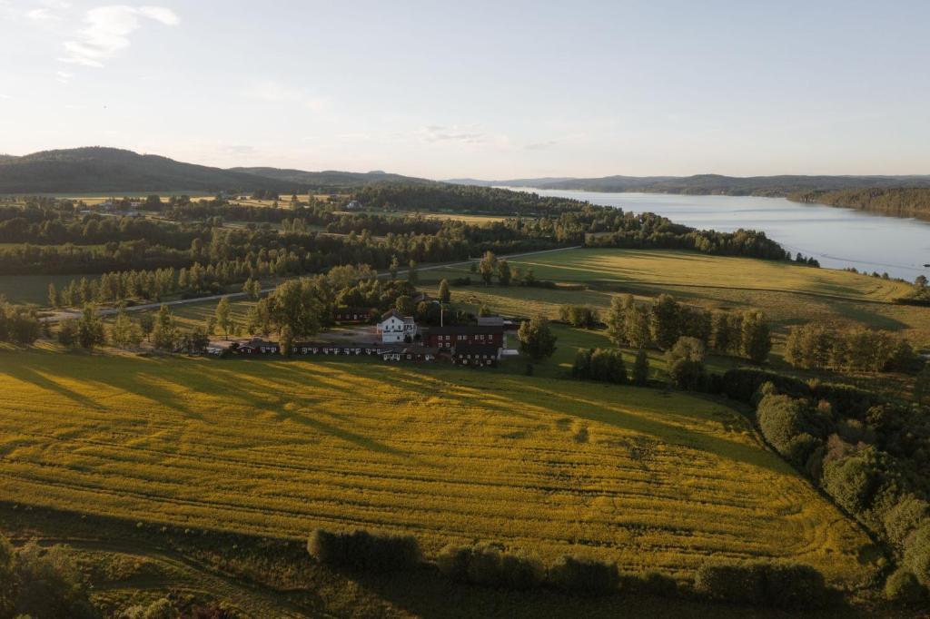 an aerial view of a house in a field next to a lake at Ulvsby Herrgård in Sunne