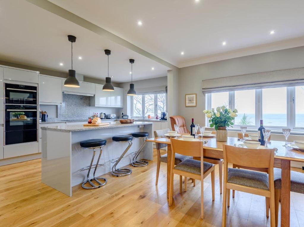 a kitchen and dining room with a table and chairs at 4 Bed in Llandudno 80288 in Rhôs-on-Sea