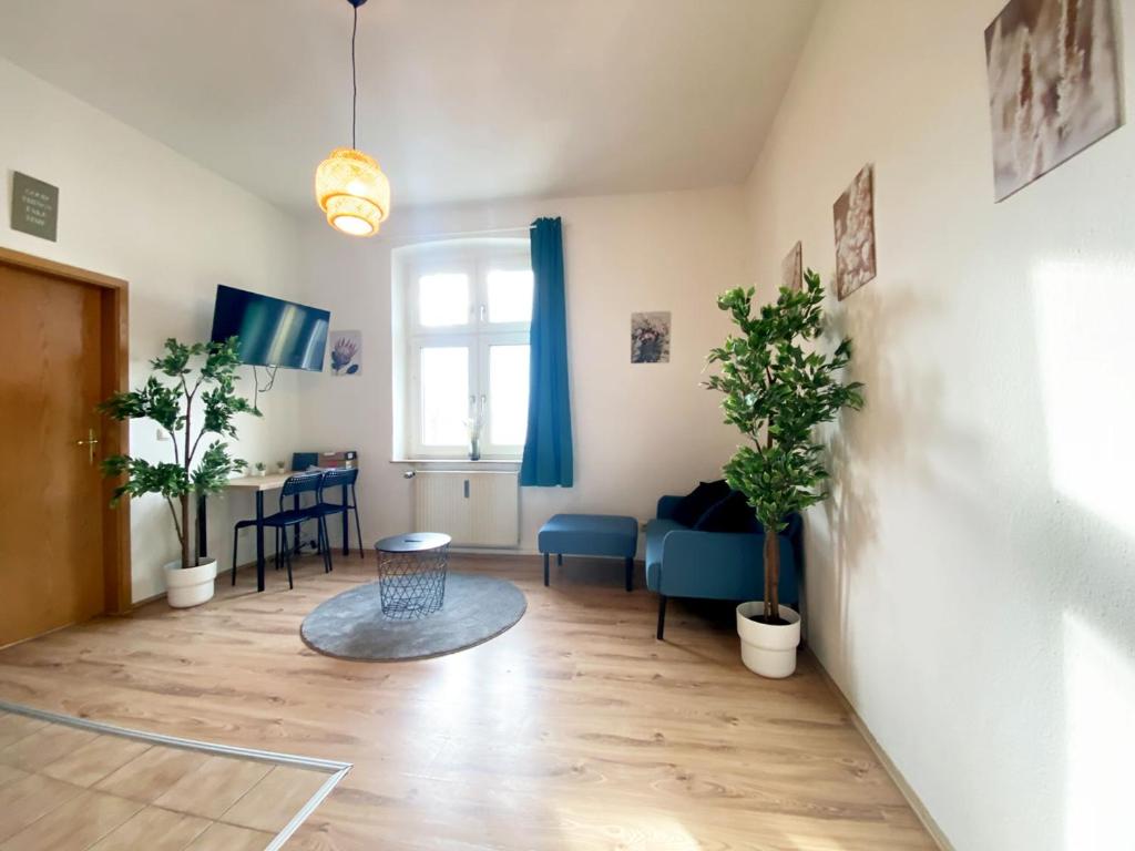 una sala de estar con mesa y plantas. en Nice Apartment in Essen, en Essen