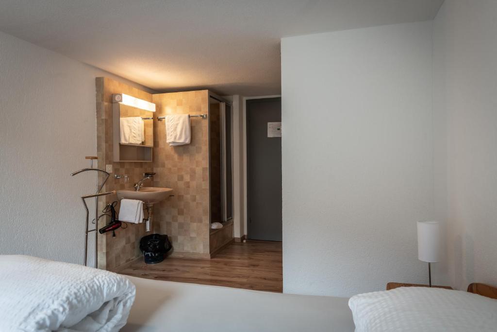 Postel nebo postele na pokoji v ubytování Hotel Greina