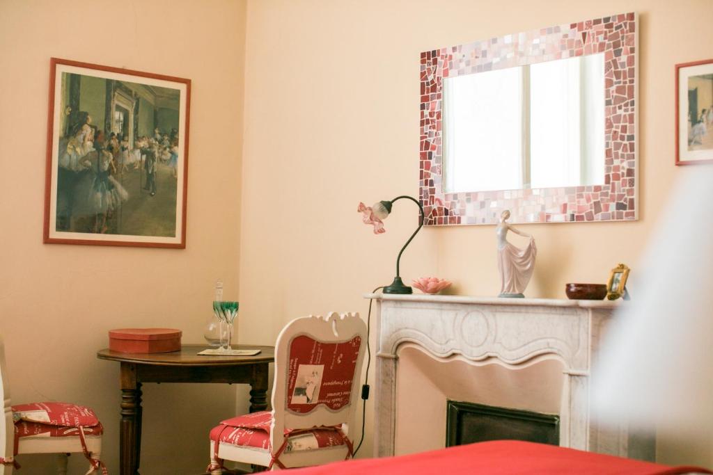 a living room with a fireplace and a window at B&B Agapantus in una Villa dell'800 in Dolceacqua