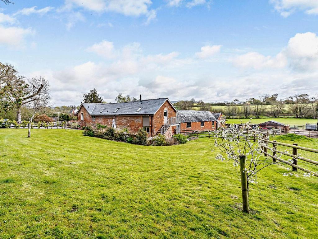 a house in a field with a fence at 4 bed in Sidmouth 53068 in Payhembury