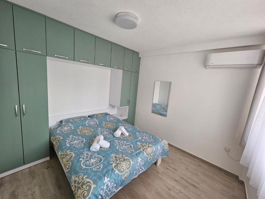 a bedroom with a bed with two stuffed animals on it at Happy apartments Strumica in Strumica