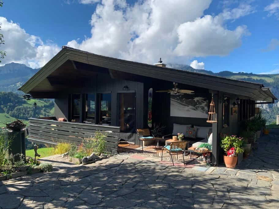 a house with a patio and a table and chairs at Drop In mountain chalet 