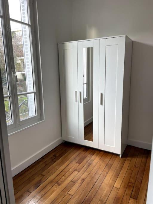 a white cabinet in a room with a window at Charmant 2 pièces proche RER B direction Paris in Fontenay-aux-Roses