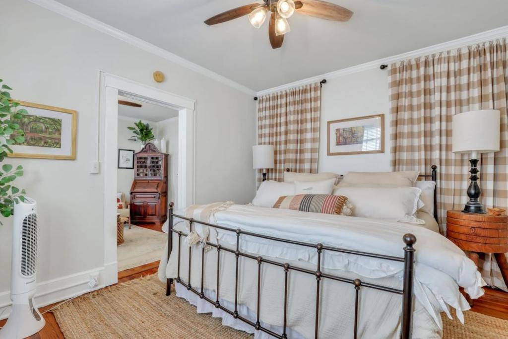 a bedroom with a bed and a ceiling fan at Southern Belle on Oglethorpe Square in Savannah