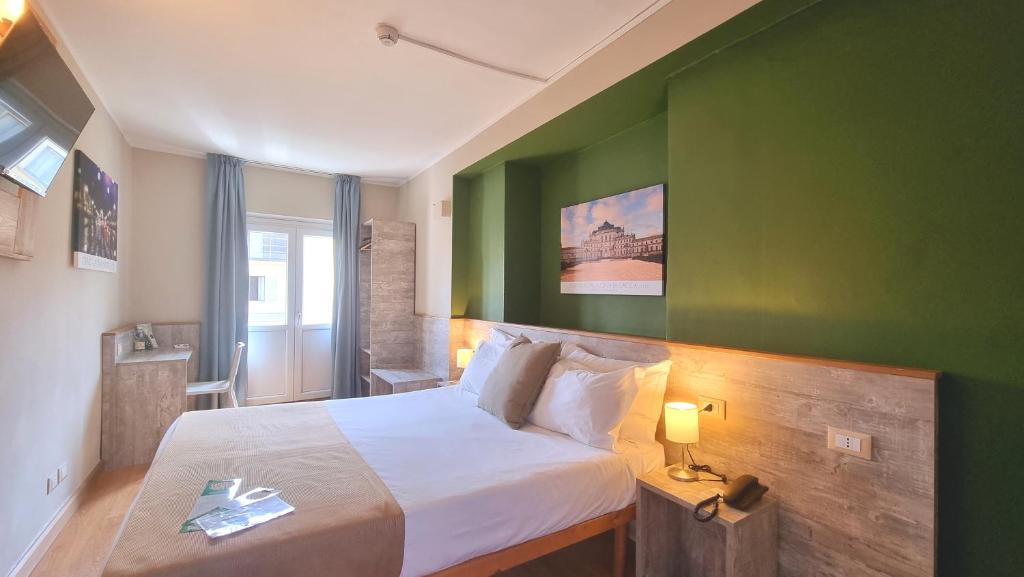 Postel nebo postele na pokoji v ubytování Green Class Hotel Astoria