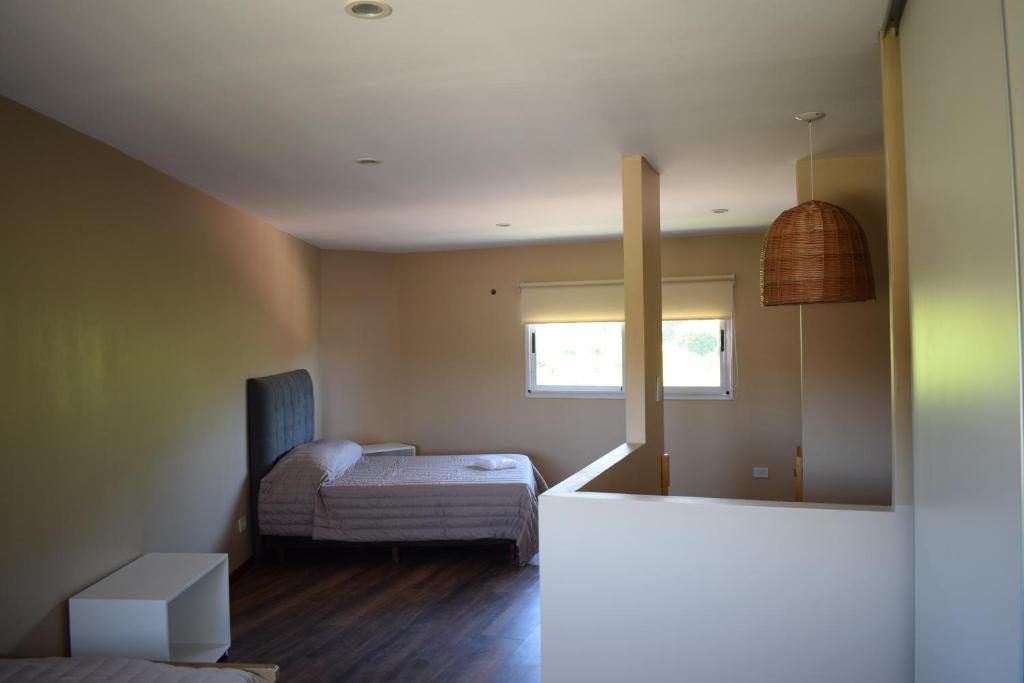 um pequeno quarto com uma cama e uma janela em Duplex Jacaranda I em Ciudad Evita