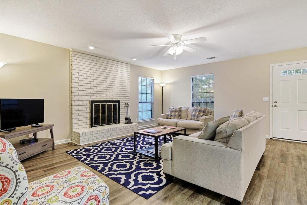 a living room with a couch and a tv at Historic Downtown Hideaway in Statesboro