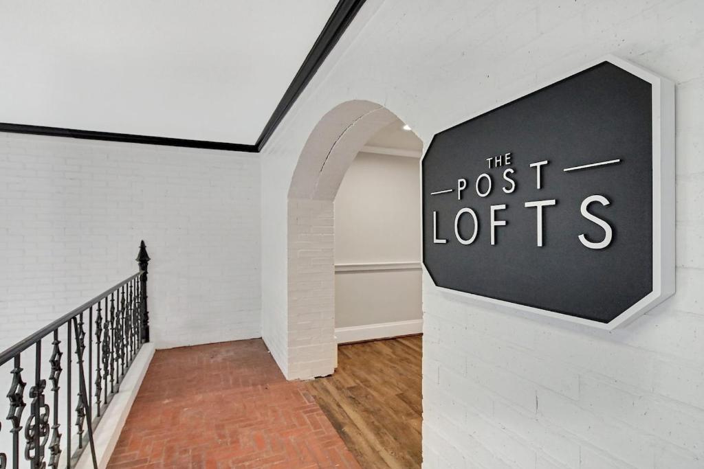 a hallway with a sign that reads the post lotts at Eagle Exec Loft In Downtown Statesboro in Statesboro