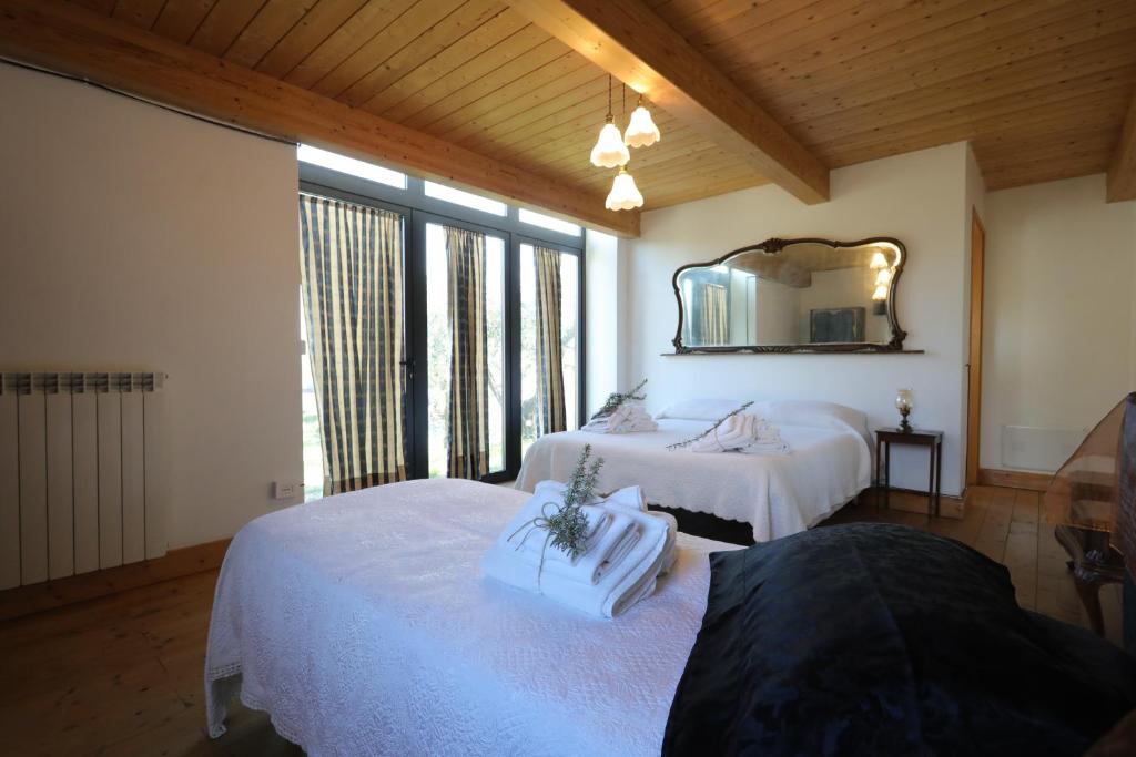 a bedroom with two beds and a mirror at Agriturismo Madre Terra in Narni