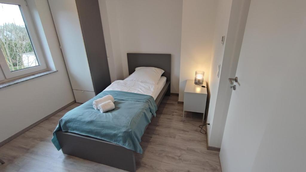 Un dormitorio pequeño con una cama y una ventana. en Dammstraße 24-OG-ZV38, en Salzgitter