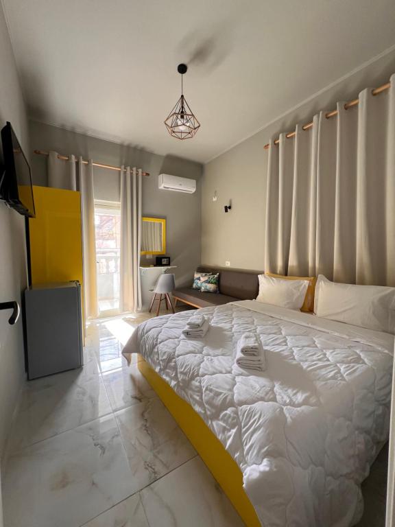a bedroom with a large white bed in a room at Jonian Boutique Hotel in Sarandë