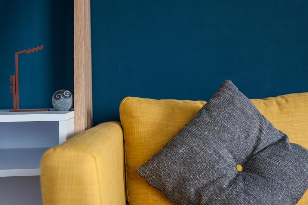 a yellow couch with a pillow in a room at Port Aran House in Kilronan