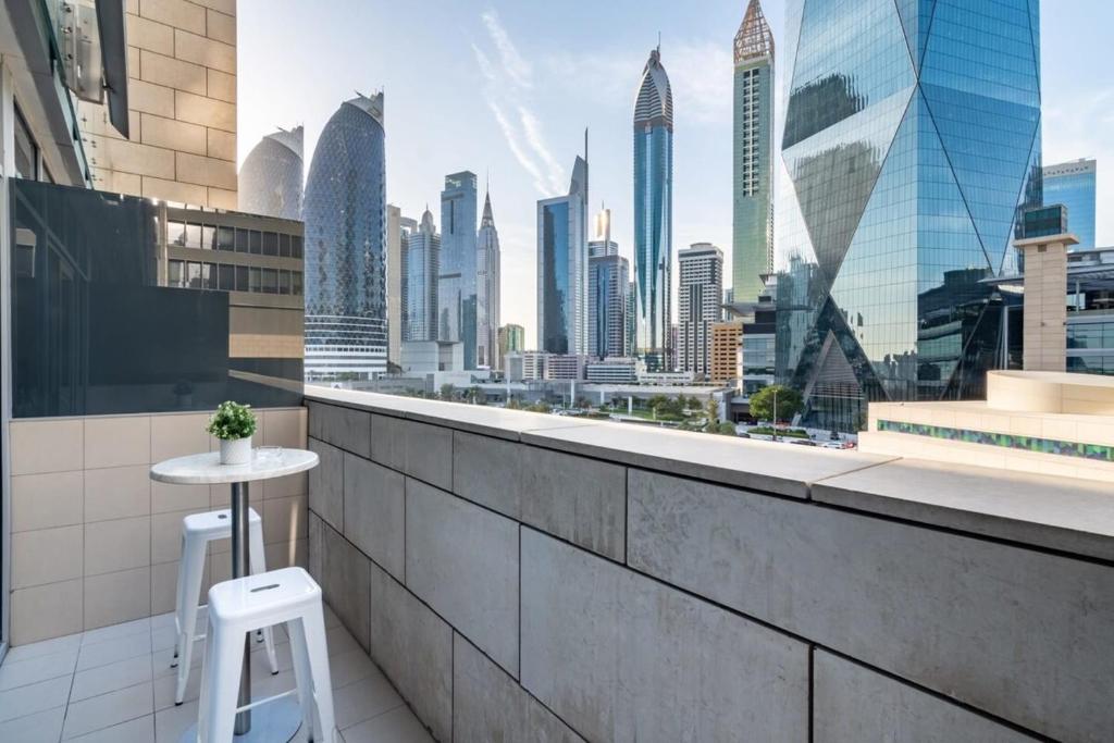 a balcony with a view of a city skyline at Silkhaus Dubai Financial Center studio in Burj Daman in Dubai