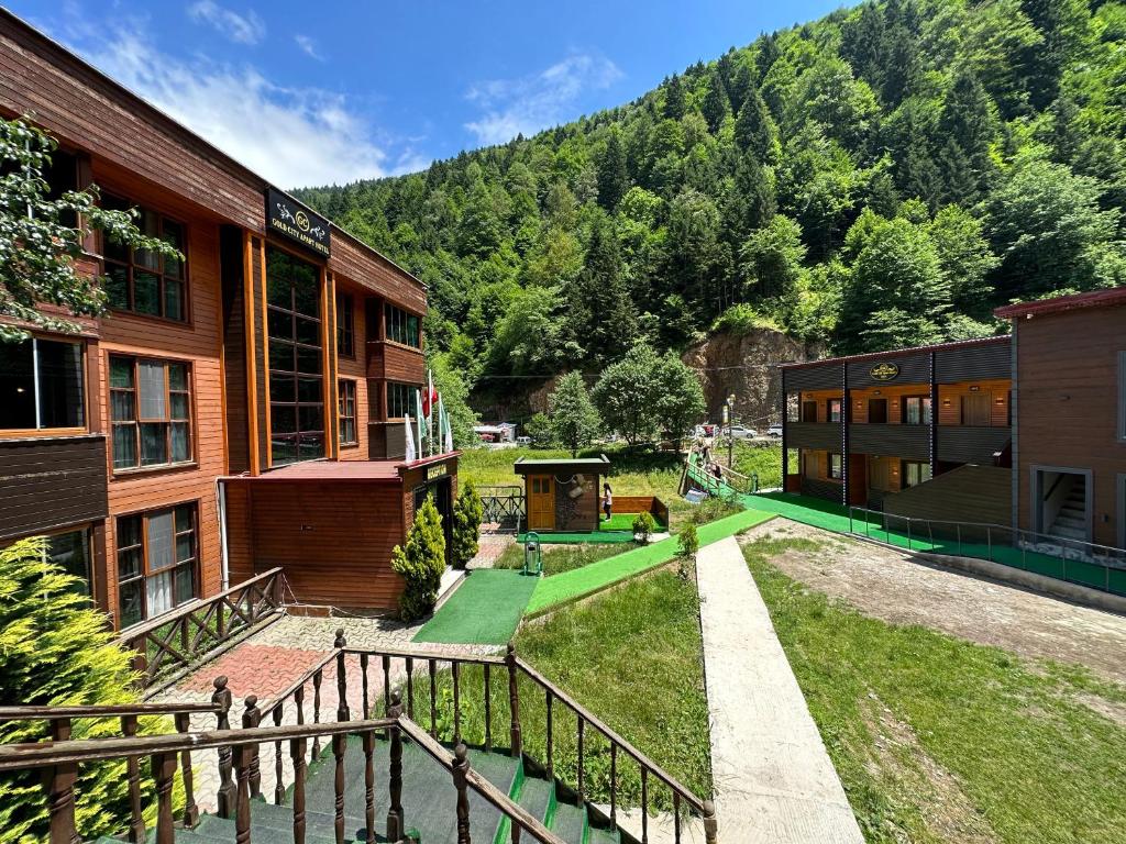 a group of buildings with a mountain in the background at Bavul Suite in Uzungöl