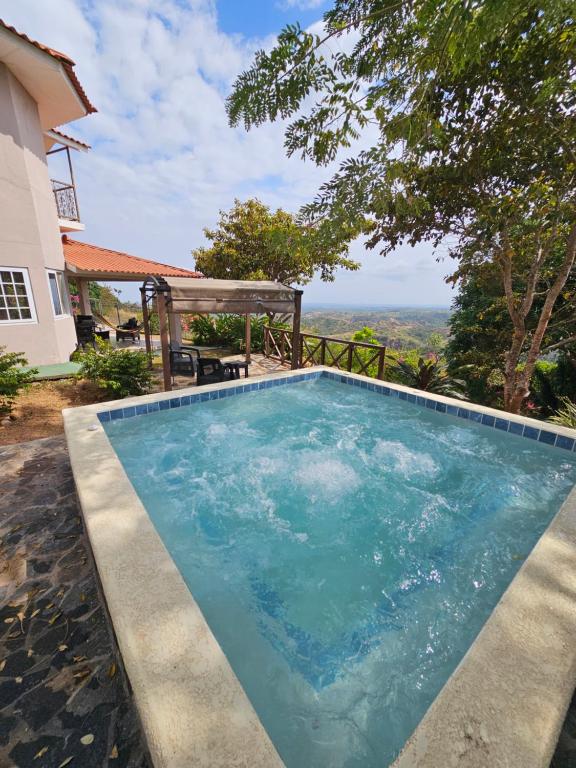 a swimming pool in front of a house at Casa Neblinas in San Carlos