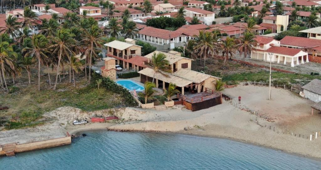 an aerial view of a house with a beach at Pousada Por do Sol in Barra Nova