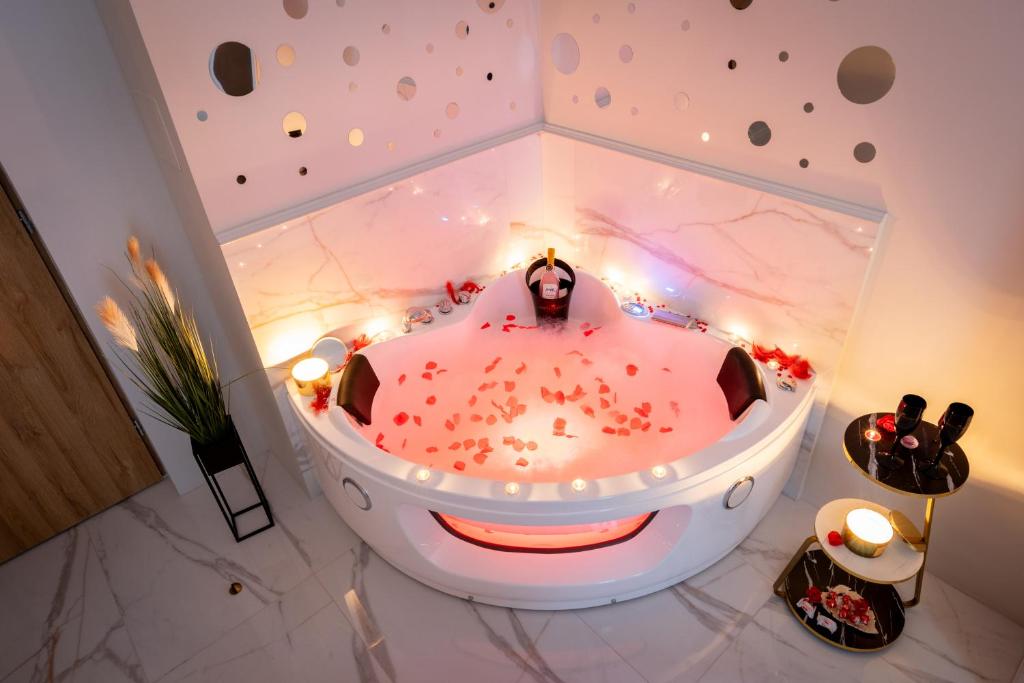 a bathtub in a room with a person in it at Jacuzzi Berka Apartamenty in Krakow