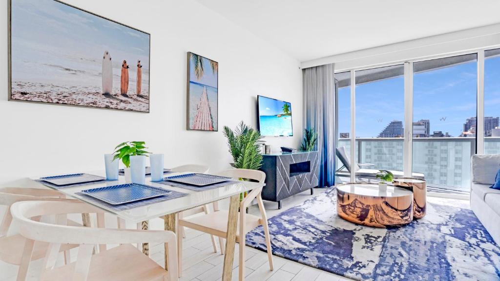 a living room with a table and chairs and a couch at Luxury High Floor Corner 1BR Unit at W Resort Fort Lauderdale-Well stocked in Fort Lauderdale