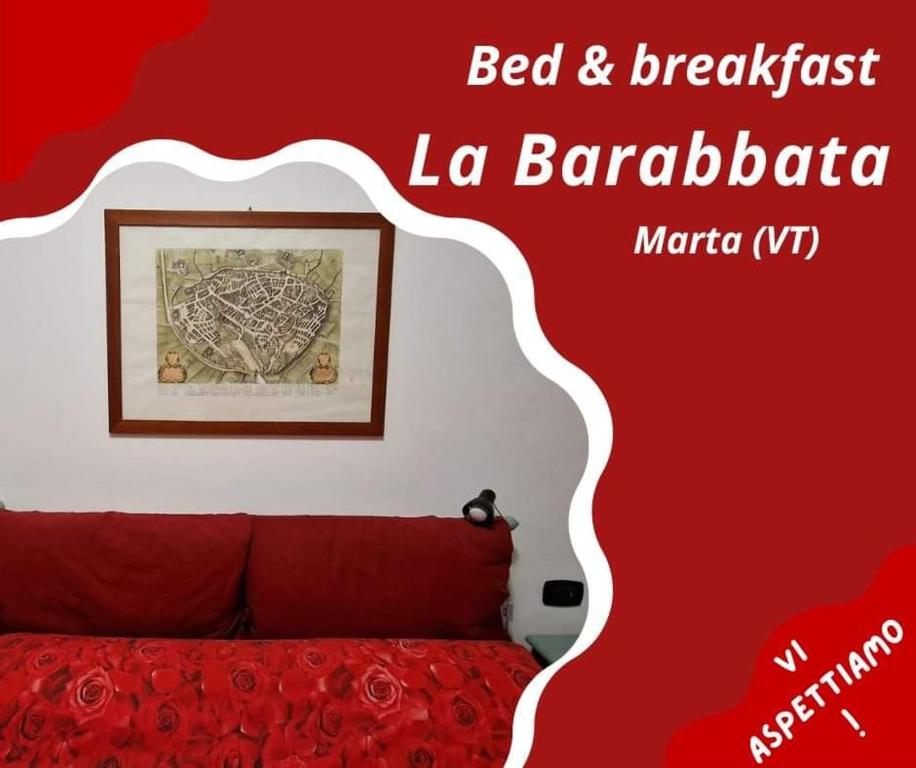 um quarto com uma cama e uma parede vermelha em La Barabbata em Marta