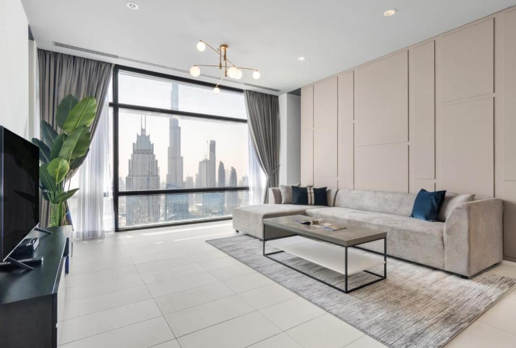 a living room with a couch and a table at Silkhaus Index Tower 1BDR with stunning view in DIFC in Dubai