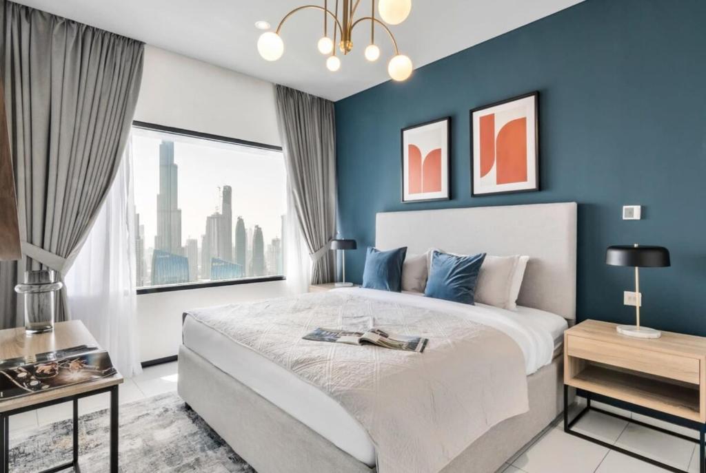 a bedroom with blue walls and a large bed at Silkhaus Index Tower 1BDR with stunning view in DIFC in Dubai