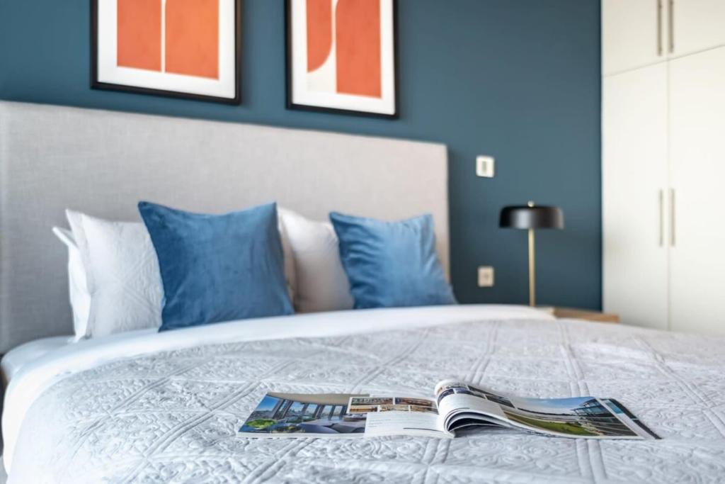 a bedroom with a bed with a book on it at Silkhaus Index Tower 1BDR with stunning view in DIFC in Dubai