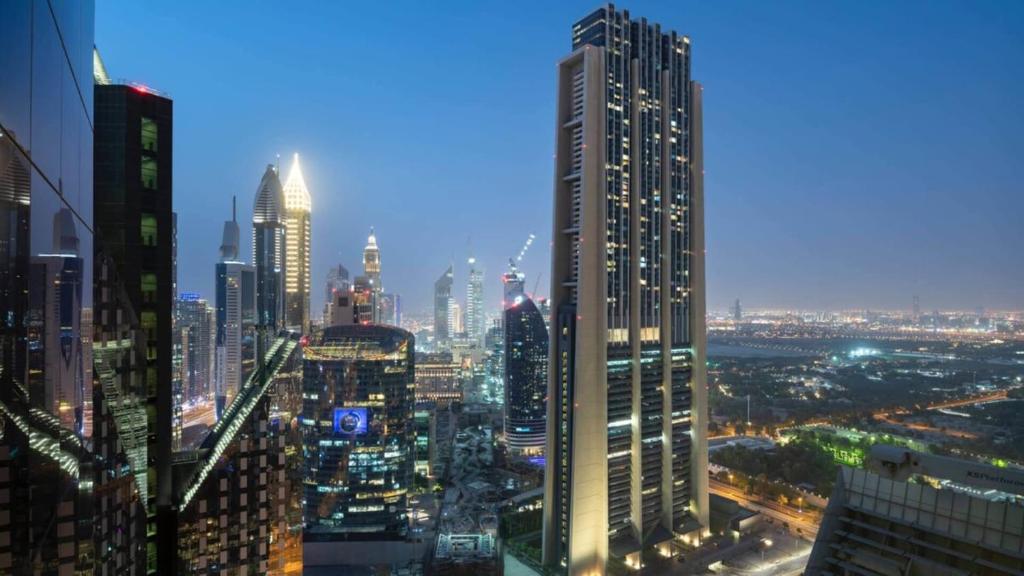 a view of a city skyline at night at Silkhaus Index Tower 1BDR with stunning view in DIFC in Dubai
