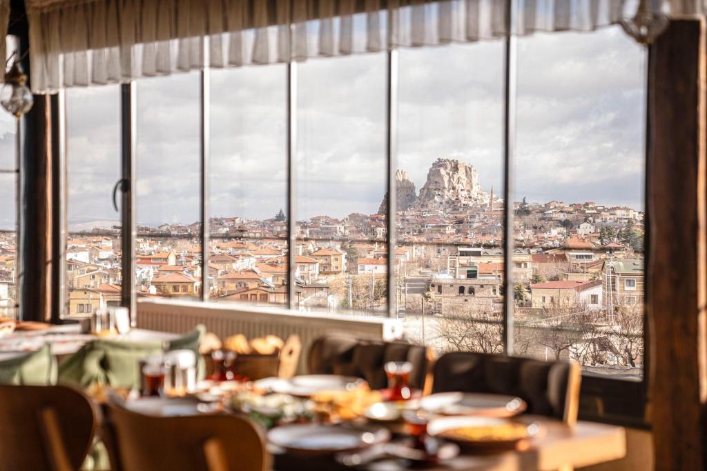 a restaurant with a view of the city from a window at Lunas Cappadocia in Nevşehir