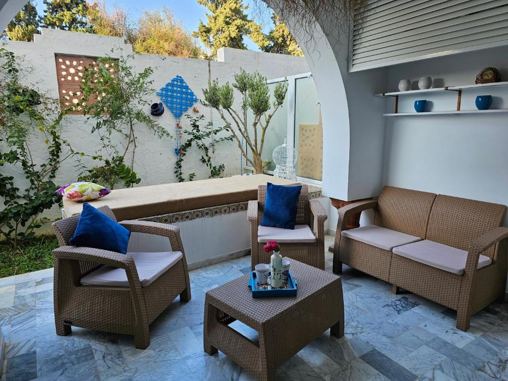 a patio with two chairs and a table at Villa Jasmin Super equipped apartment with Garden, Swimming pool, Sea in Hammamet