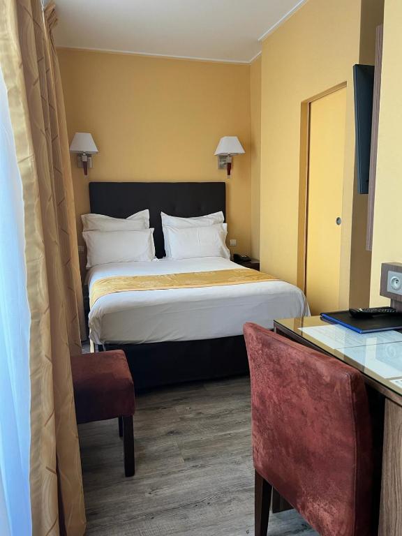 Postel nebo postele na pokoji v ubytování Hotel Capitole