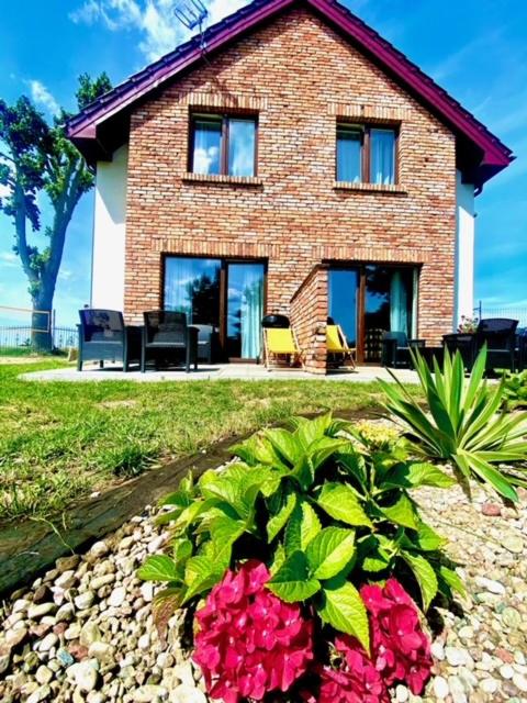 a brick house with flowers in front of it at Wczasy u Moniki in Władysławowo