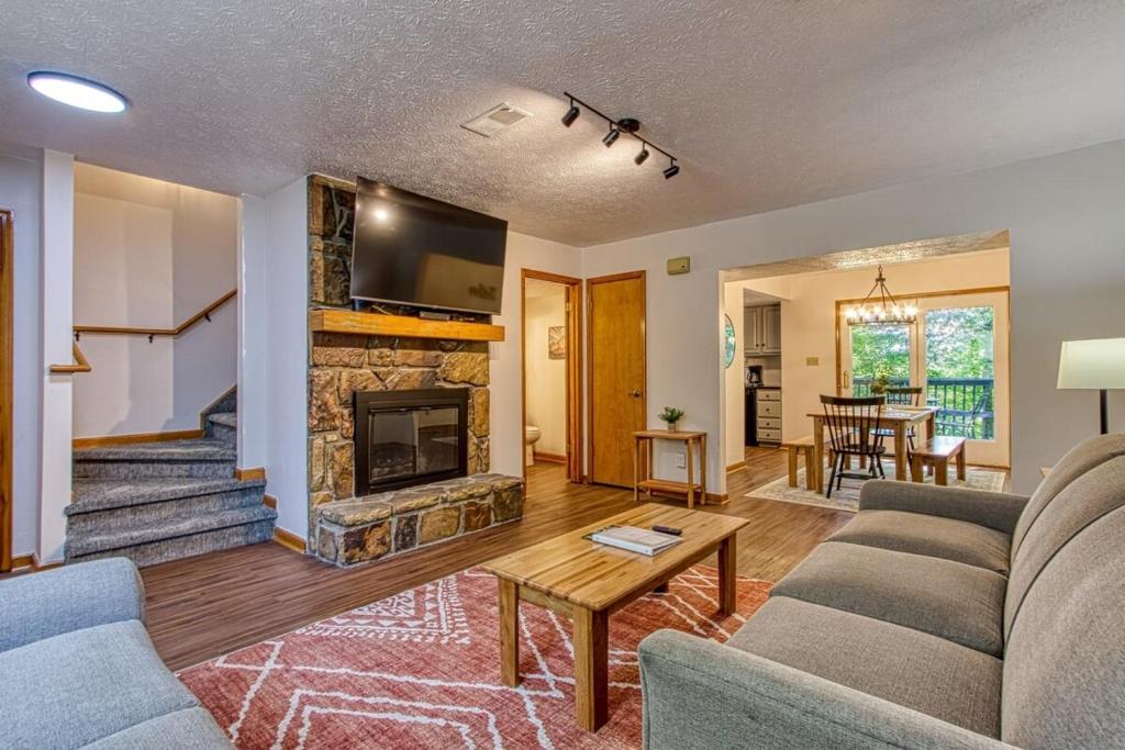 a living room with a couch and a fireplace at Pool-Pinecrest Townhomes-Two Units-Dollywood-Renovated in Pigeon Forge